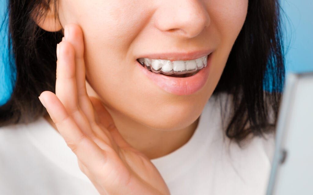 Woman holding pained tooth